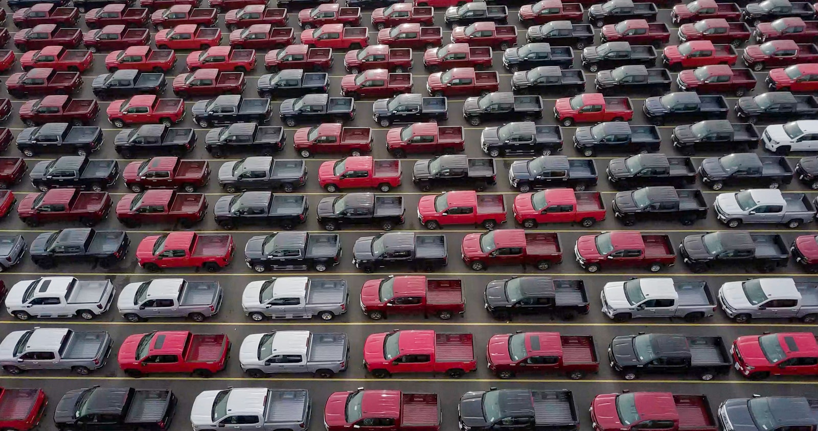 red and black cars on parking lot during daytime